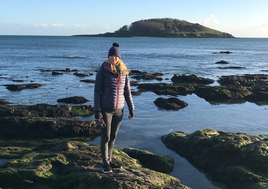 Melanie and Lily, her dog, on a winter beach in Looe, Cornwall.