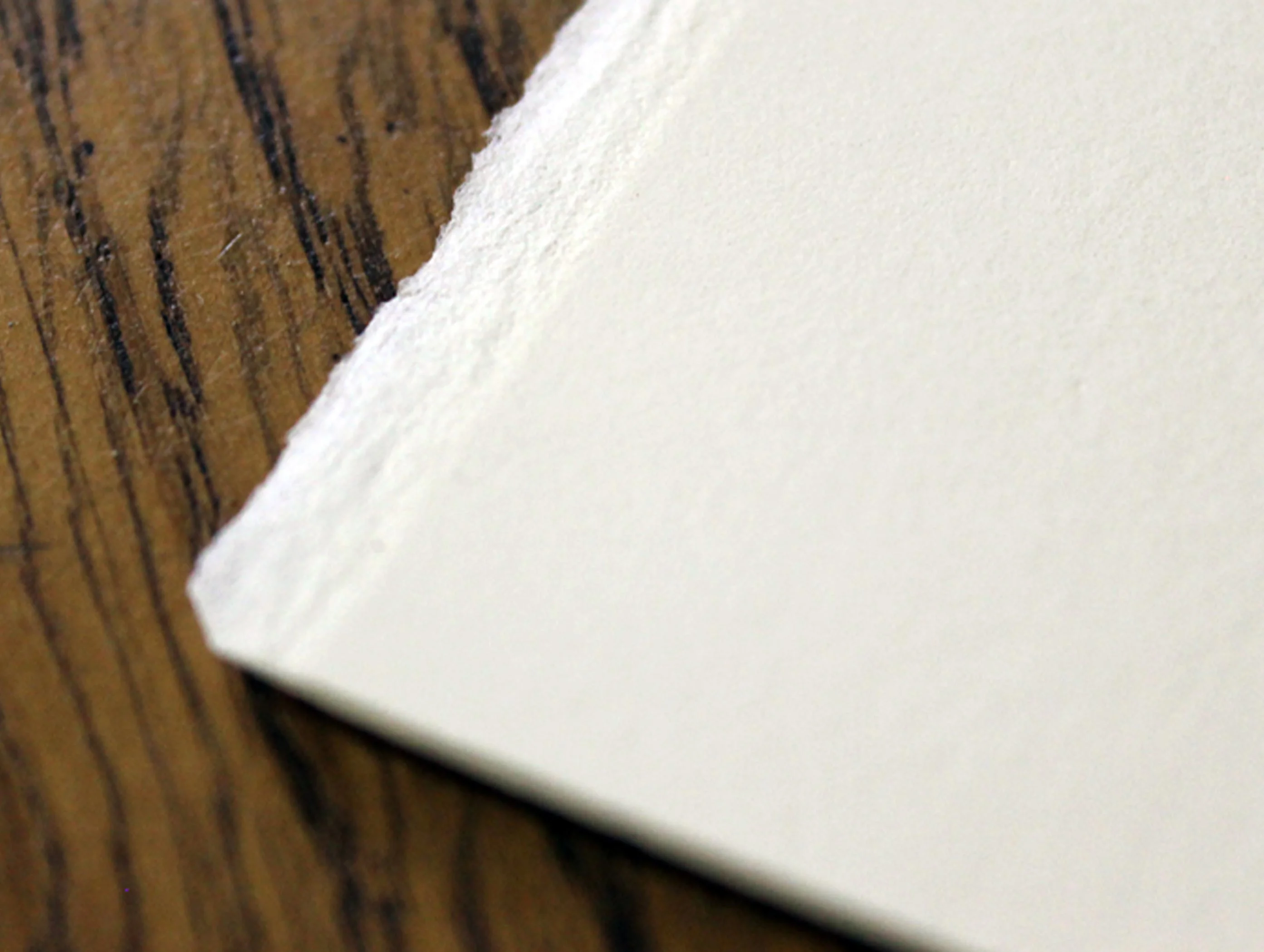 Close-up of Fabriano paper, highlighting its textured surface and deckled edge.