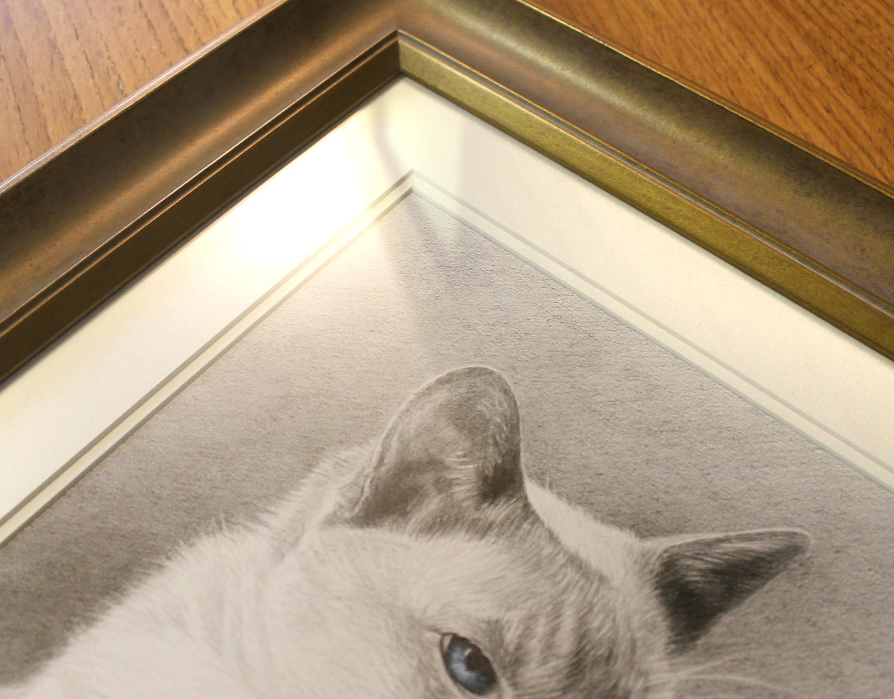 Close-up of Max's memorial cat portrait, showing his name painted with ashes and an actual whisker.
