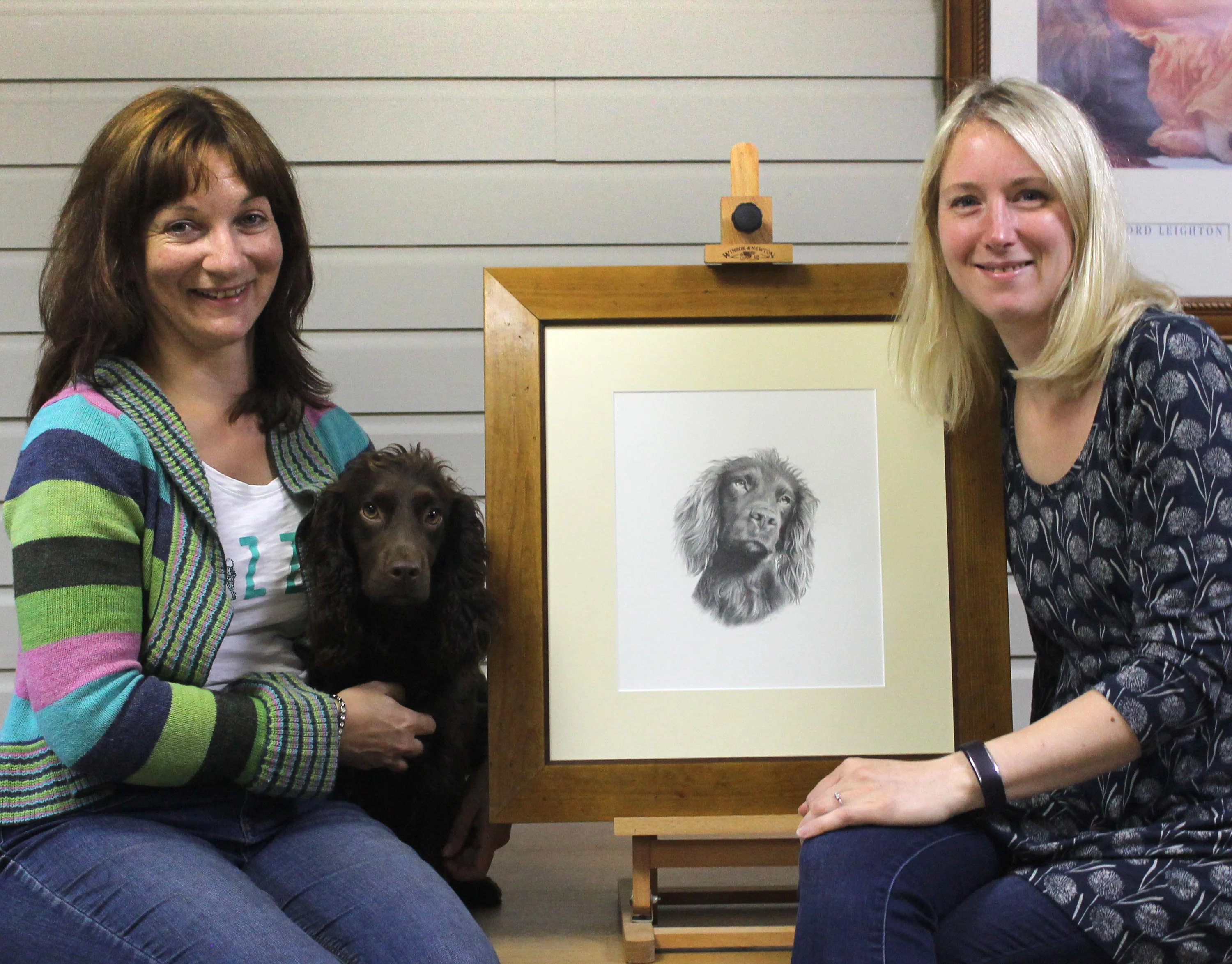 Tracey and Moo the Cocker Spaniel with artist Melanie Phillips and the finished portrait.